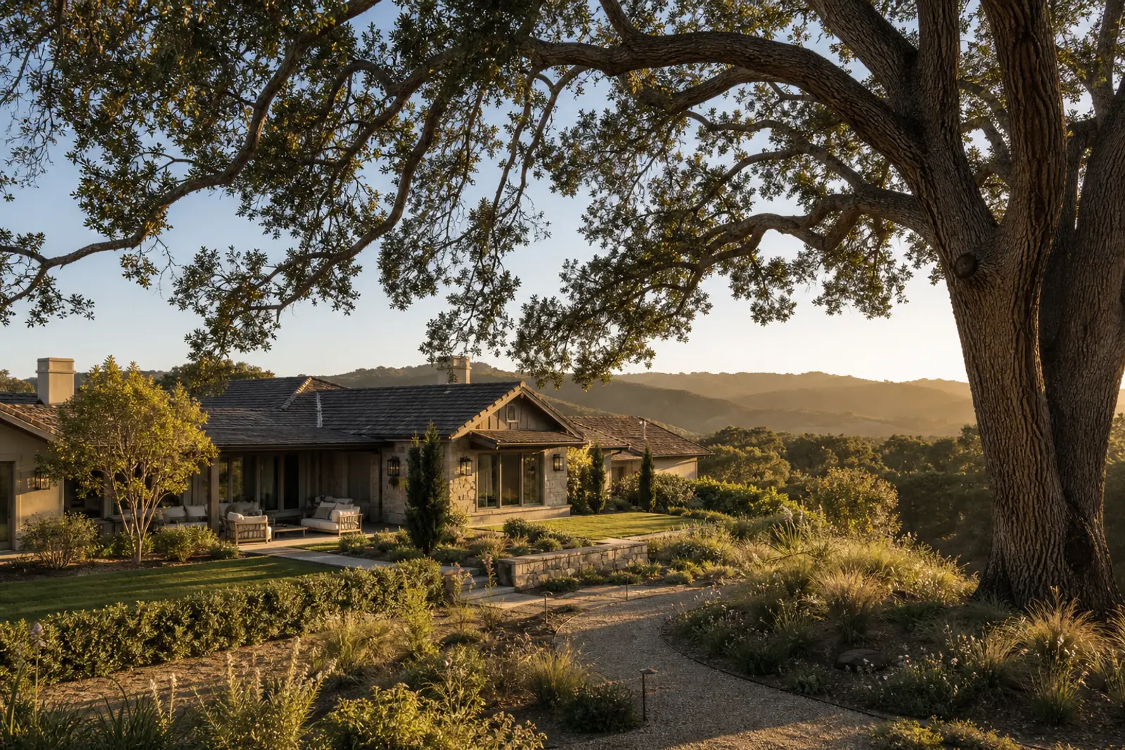 Ranch homes beneath old oak trees in Thousand Oaks with open-space hills beyond