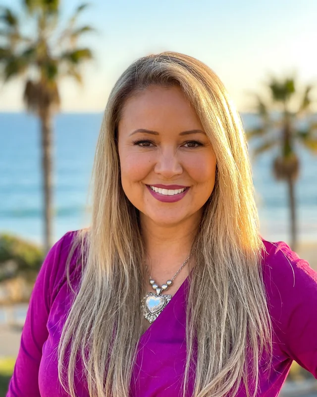 Monique Monroe, Realtor, smiling warmly against a sunny California backdrop